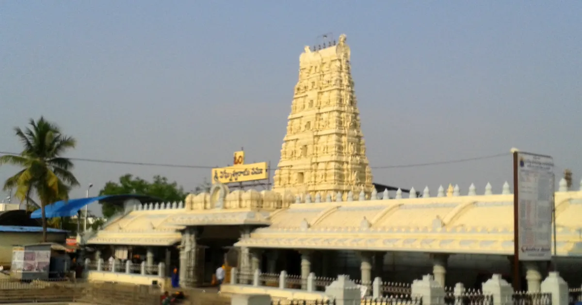 The white gopuram and front hall of the Kanipakam temple in Andhra Pradesh, seen from across an open courtyard