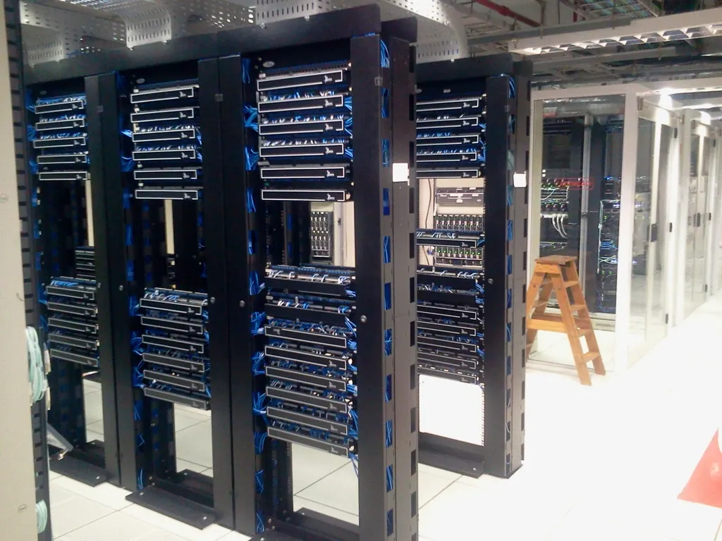 Rows of network racks with cables in a computer server room