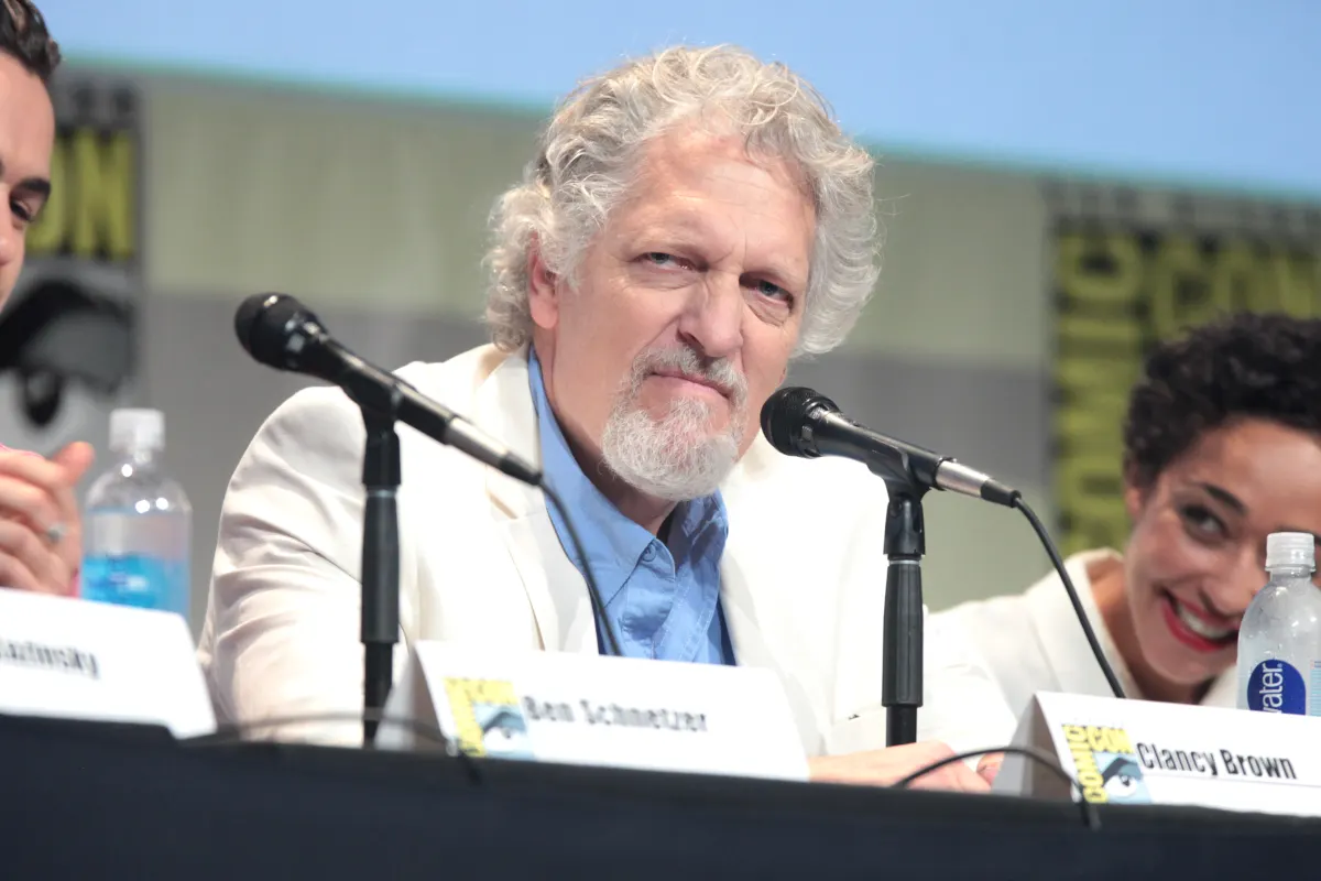 Actor Clancy Brown speaking into a microphone at a San Diego Comic-Con panel table