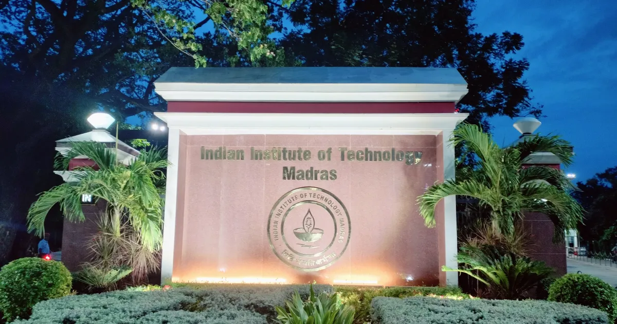Indian Institute of Technology Madras main gate sign lit up in the evening