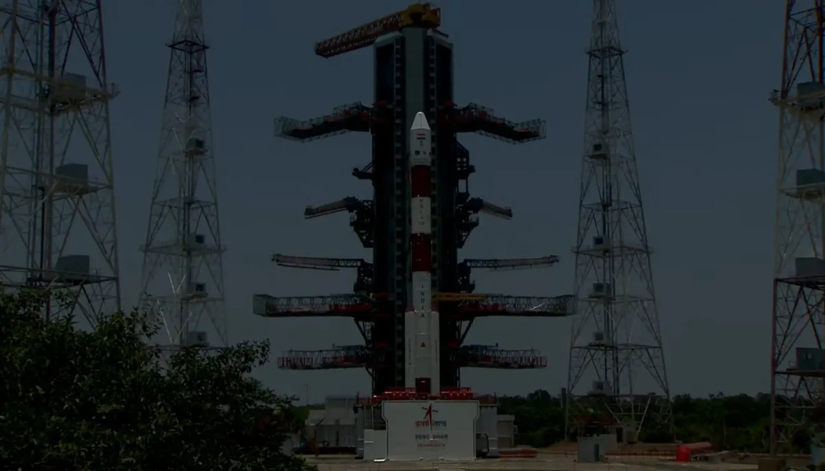 A PSLV rocket standing on the launch pad at Sriharikota between tall lightning towers, before the Aditya-L1 launch