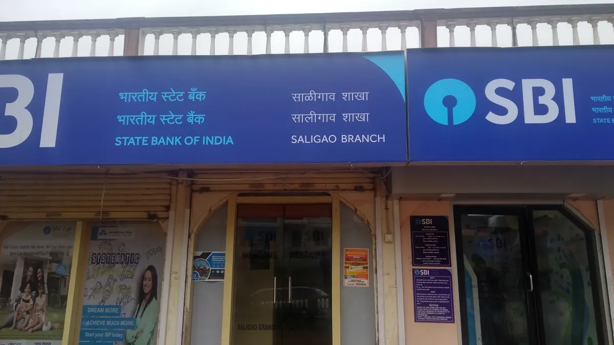 The front of a State Bank of India village branch with a blue signboard in Hindi and English