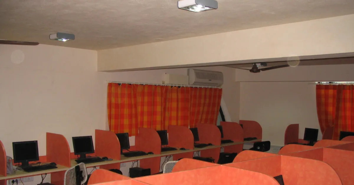 Rows of computers in partitioned desks inside a computer lab in Chennai, similar to an online exam centre