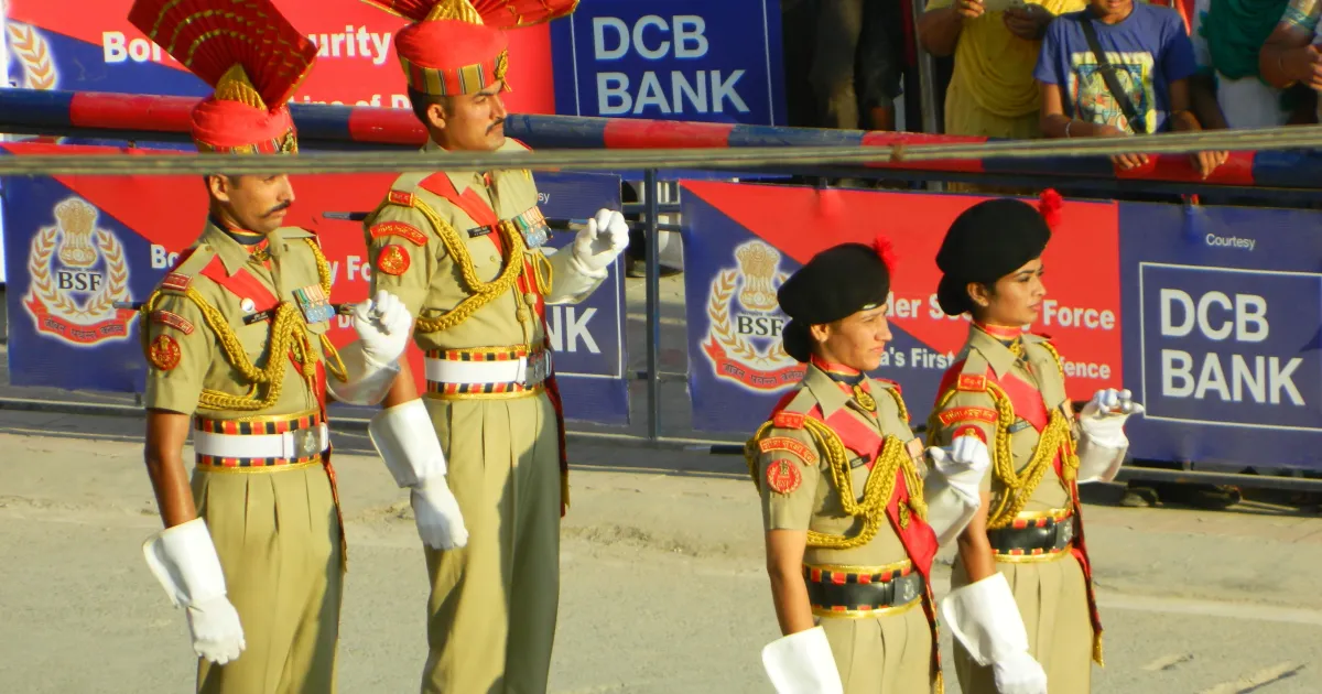 Male and female BSF personnel in ceremonial uniform standing at a parade