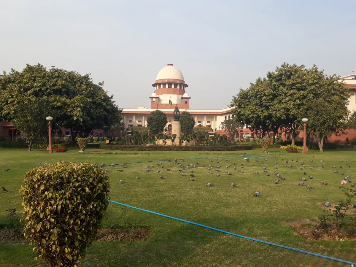 Front view of the Supreme Court of India building with its lawns