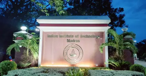 Indian Institute of Technology Madras main gate sign lit up in the evening