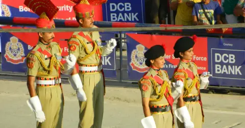 Male and female BSF personnel in ceremonial uniform standing at a parade