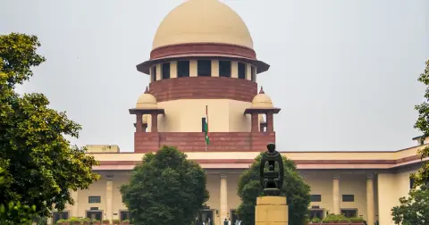 The domed main building of the Supreme Court of India in New Delhi, seen from the lawns